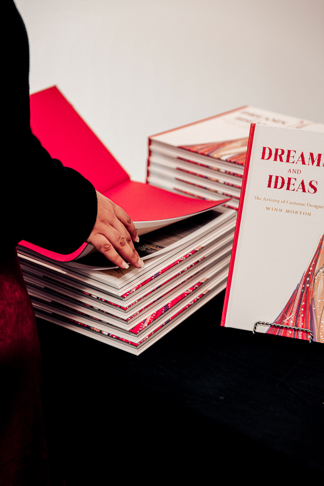 A stack of books called Dreams and Ideas: The Artistry of Costume Designer Winn Morton by Myra Walker i